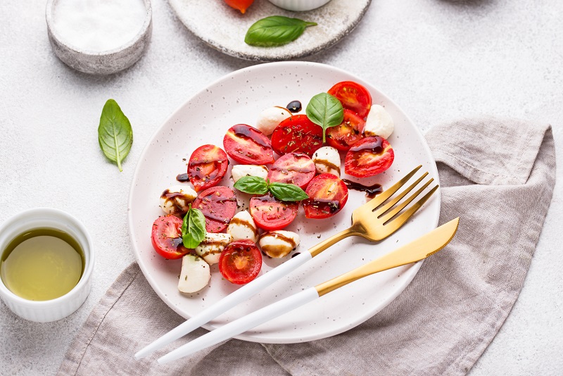 Caprese salad with cherry tomatoes and baby mozzarella cheese
