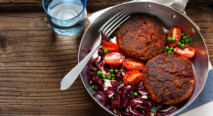 two Vegan Burgers and salad in a frying pan healthy habits