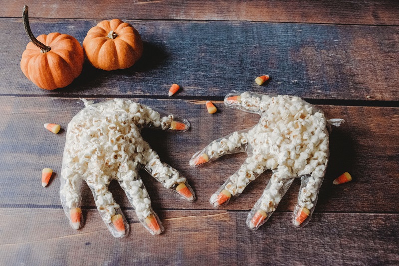 Popcorn hands with candy corn and pumpkins