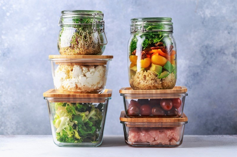 6 different containers with a variety of snacks and meal ingredients