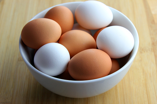 brown and white eggs in a bowl