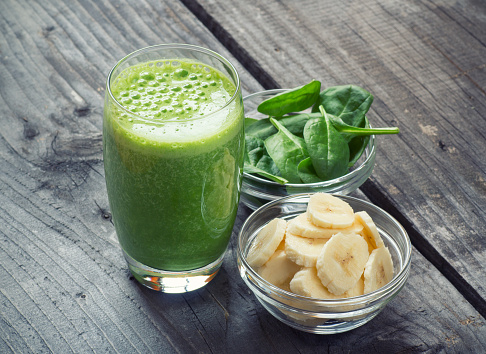 Green fresh healthy smoothie with bananas and spinach