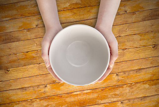 person holding an empty bowl