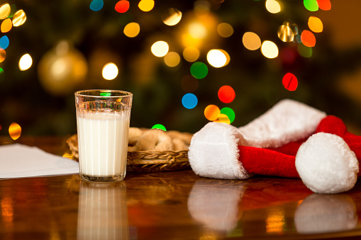 glass of milk next to santa hats