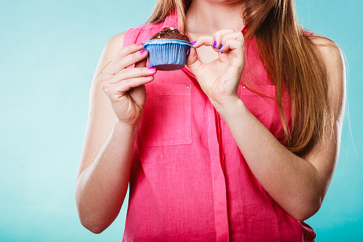 woman holding cupcake