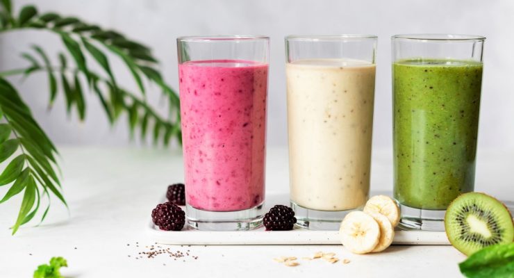 colorful smoothies with blackberries, banana and oatmeal, kiwi and spinach.