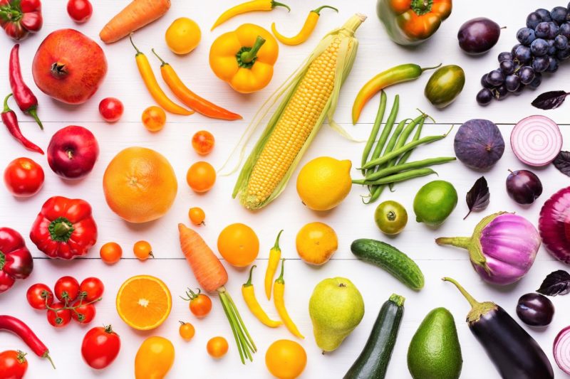 different colors of fruits and vegetables making a rainbow