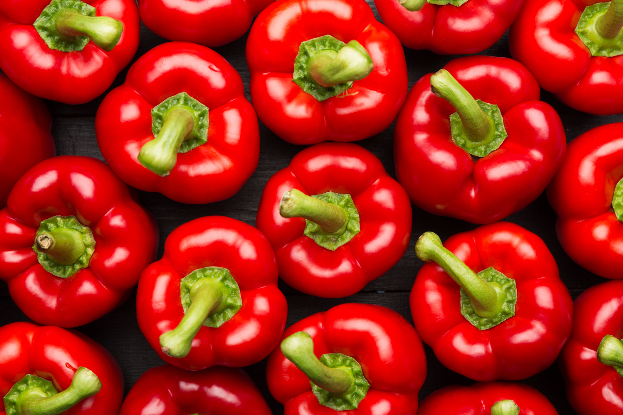 healthy red bell peppers in the produce aisle 