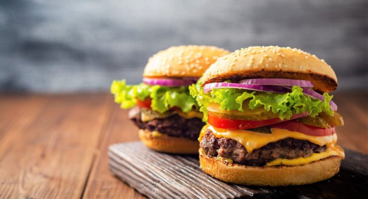 Two homemade tasty burgers on wood table