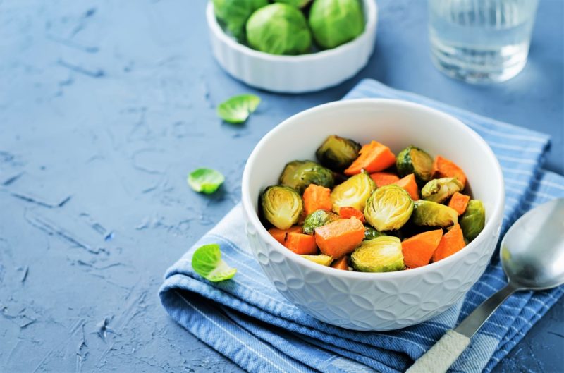 Cooked Brussels Sprouts and sweet potato in a bowl. fall produce
