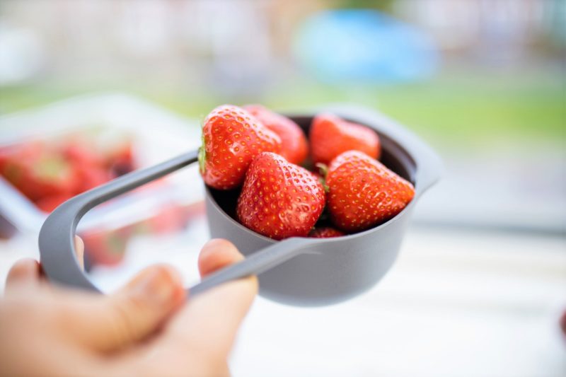 portion controlled strawberries in a measuring cup