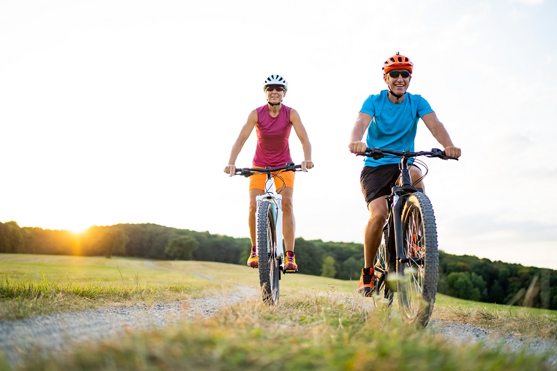 couple cycling in summer