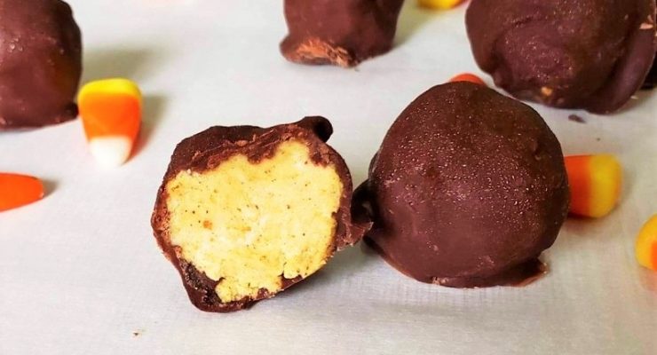 chocolate covered pumpkin truffle balls with candy corn