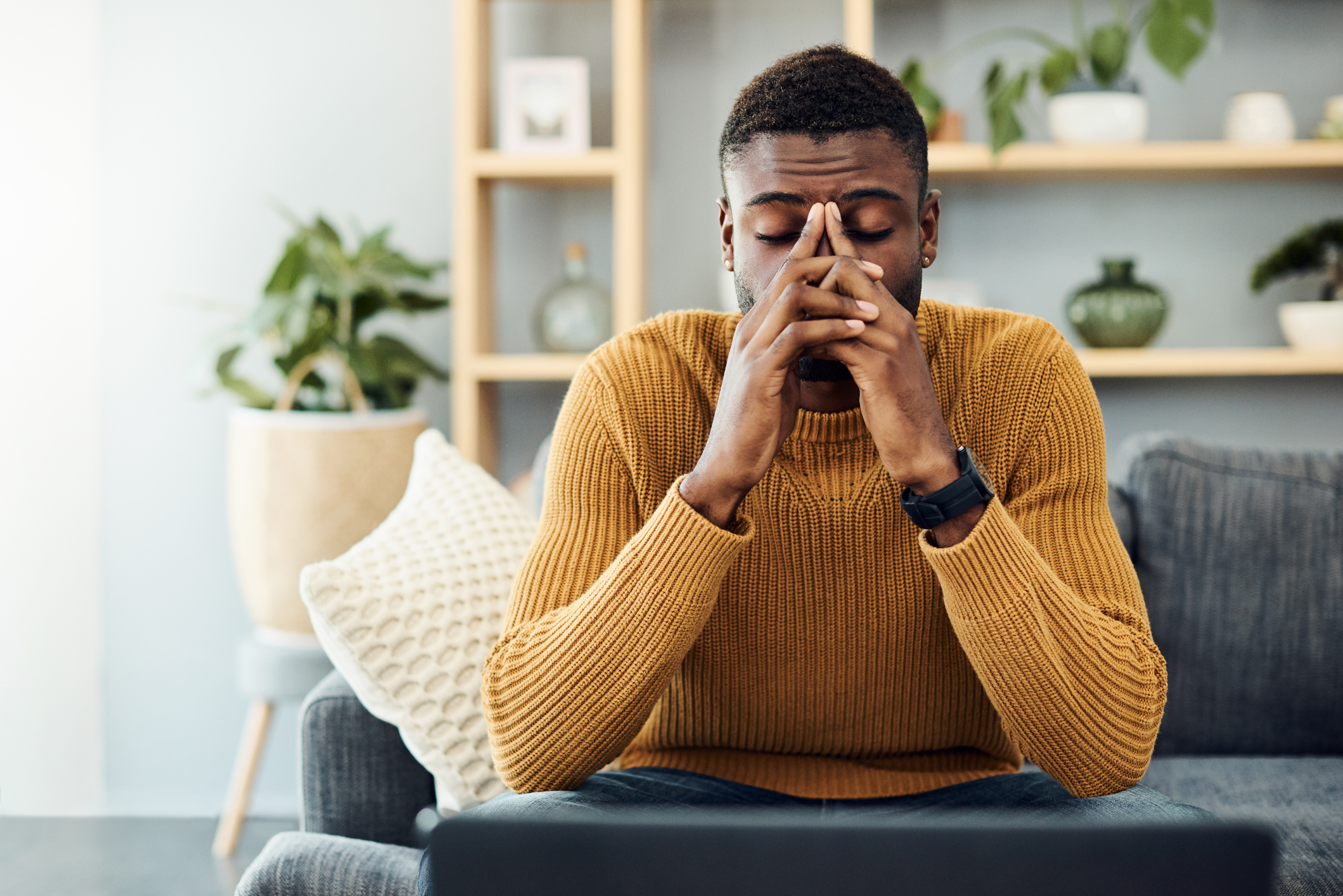 stressed-out-man-sitting-on-a-couch-the-leaf