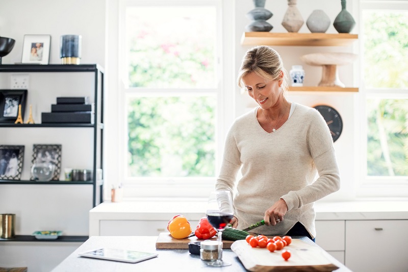 a middle-aged woman prepping fresh produce. losing weight after 40