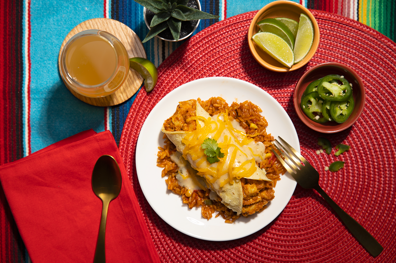Chicken Enchiladas served with limes and jalapenos on a table for Nutrisystem simple weight loss plan