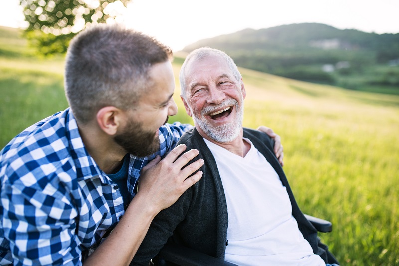 a young man and old man laughing together. men's metabolism tips