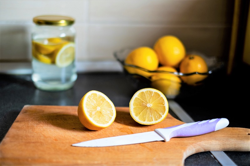 sliced lemon on a wooden cutting board. losing weight after 40