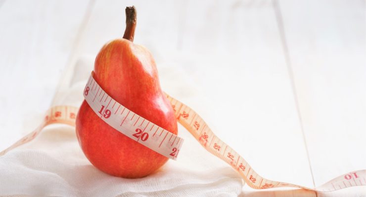 red pear wrapped in a measuring tape