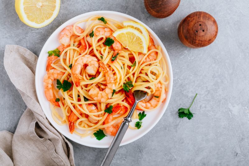 healthy pasta recipes with shrimp, lemon, and cilantro as garnish 