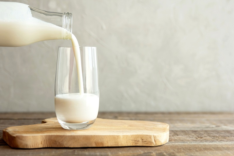 organic milk poured into a tall glass. metabolism boosting foods