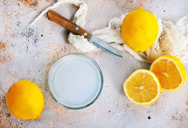 sliced lemons and lemon juice in a bowl