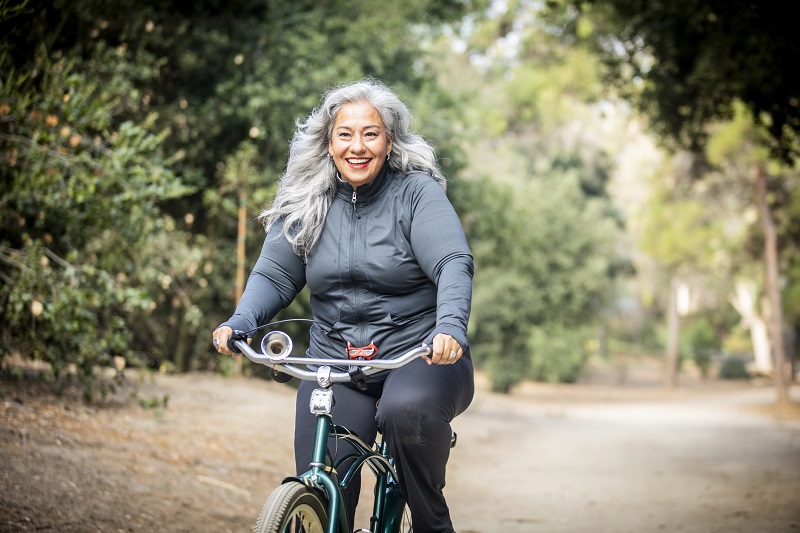 a woman cycling in a park