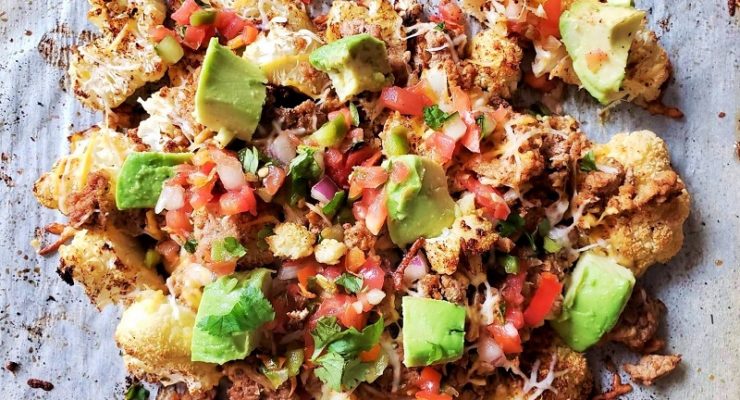 cauliflower nacho meal, with avocado, turkey, tomato, onions, and other vegetables