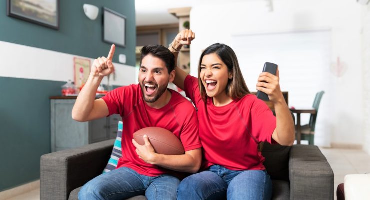 couple watching American football game