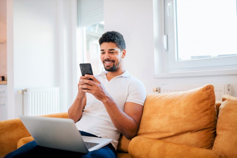 man looking at smart phone to give feedback in survey