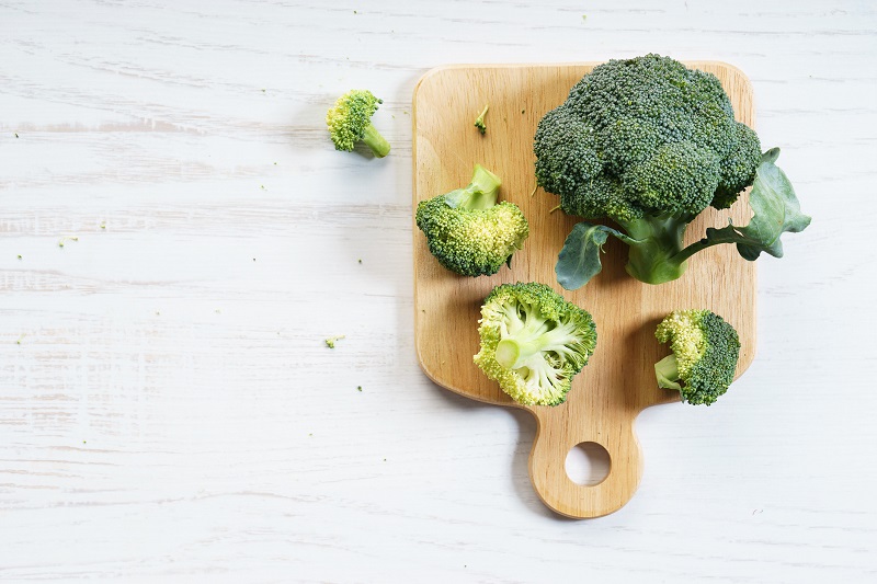 fresh broccoli on a small cutting board