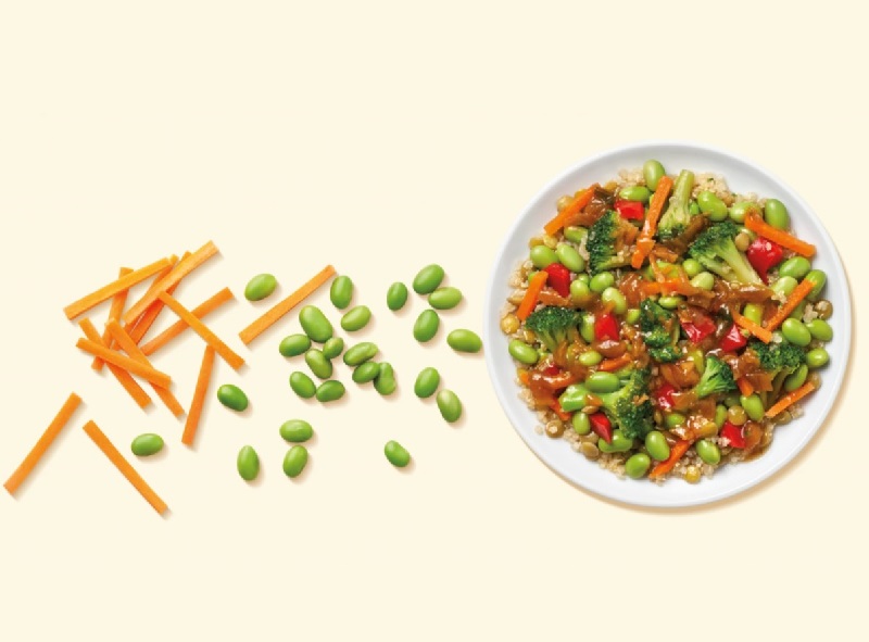 a plate of vegetables, carrots, edamame, and broccoli 