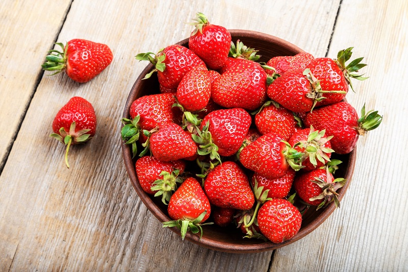 fresh in season strawberries in a bowl