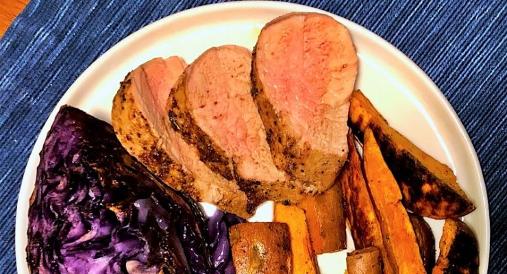 Sheet Pan Pork Tenderloin with Cabbage and Sweet Potato Fries on a plate