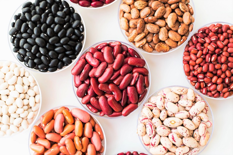 different varieties of beans in small bowls
