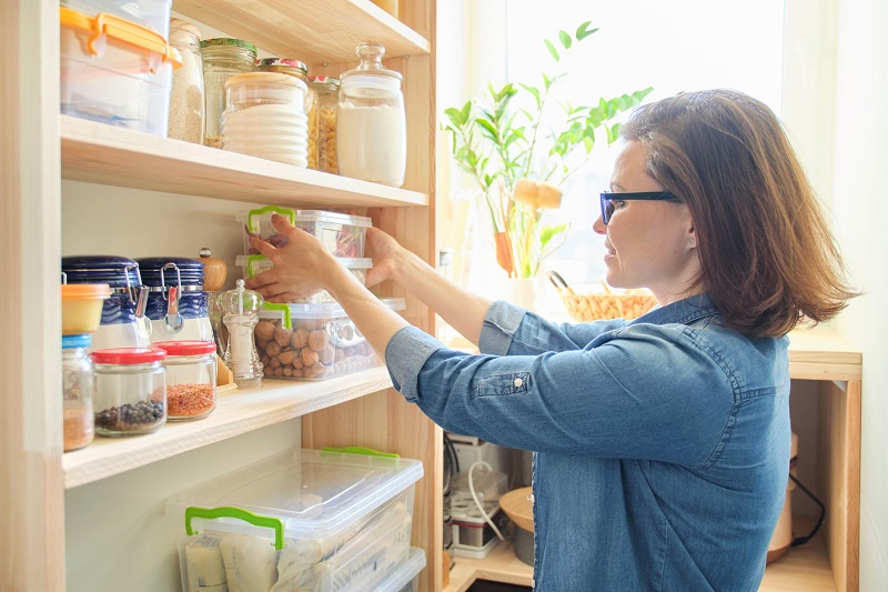 a woman organizing her pantry