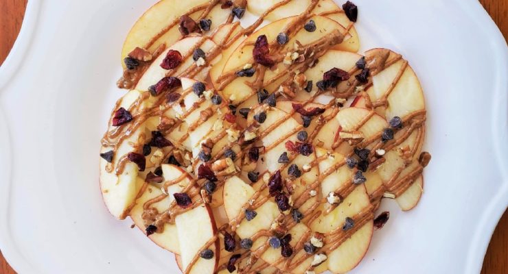 Apple Nachos: Apple Slices drizzled with almond butter and topped with pecans, cranberries and chocolate chips.