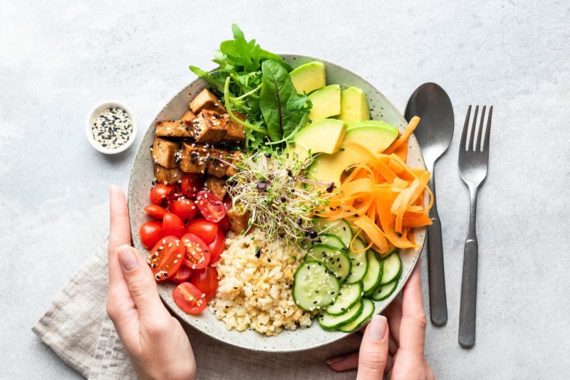 woman holding healthy power bowl