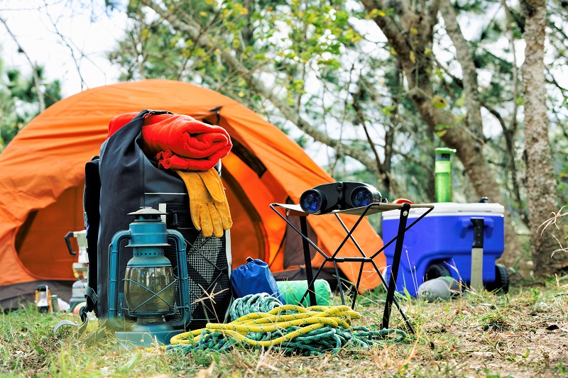 a tent and camping supplies in a natural park
