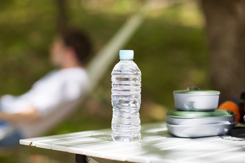 a water bottle set on an outdoor dining table