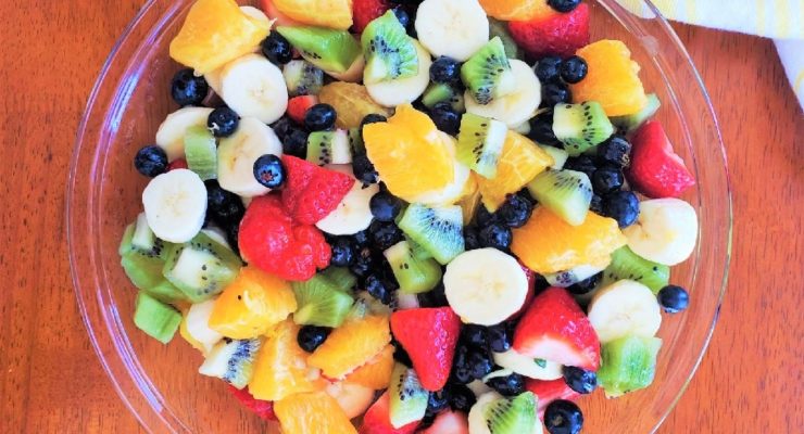Fresh healthy Fruit Salad with blueberries, strawberries, oranges, kiwis and bananas
