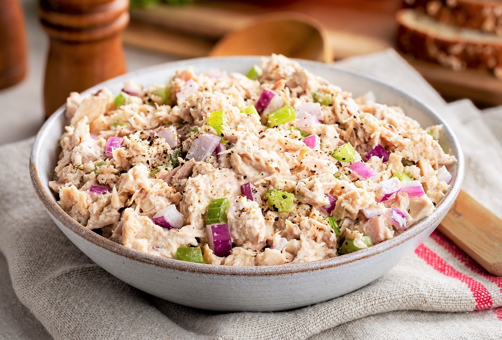 tuna salad with onions and celery in a bowl