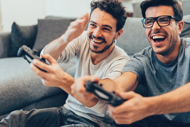 brothers playing video game laughing