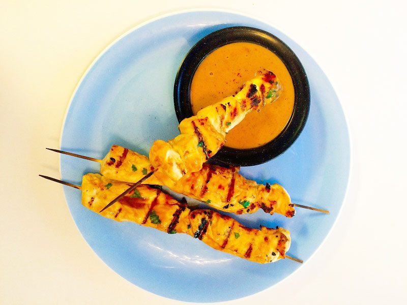 Chicken Kebabs cooked on the grill with Peanut Dipping Sauce