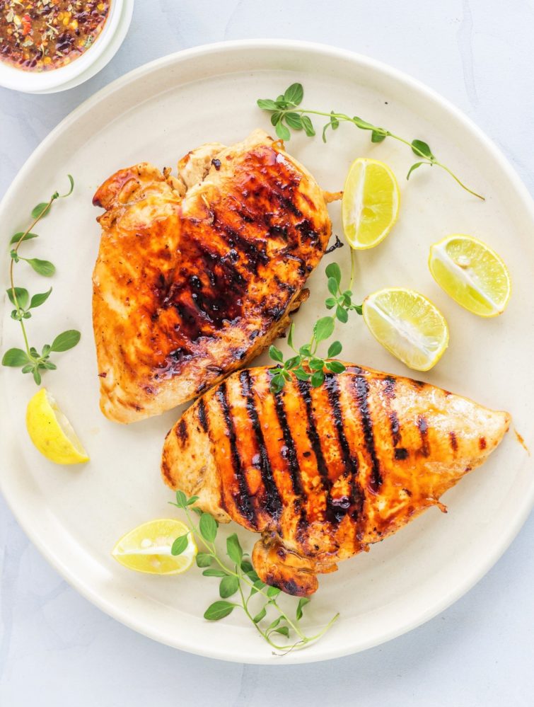 Grilled Balsamic Chicken Breast on a plate with lemon and oregano