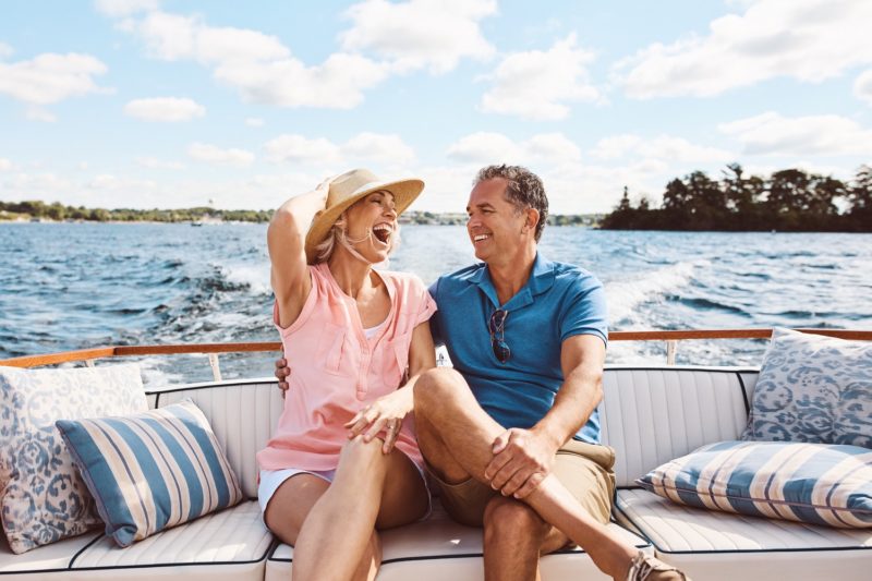 man and woman having fun on a boat during summer