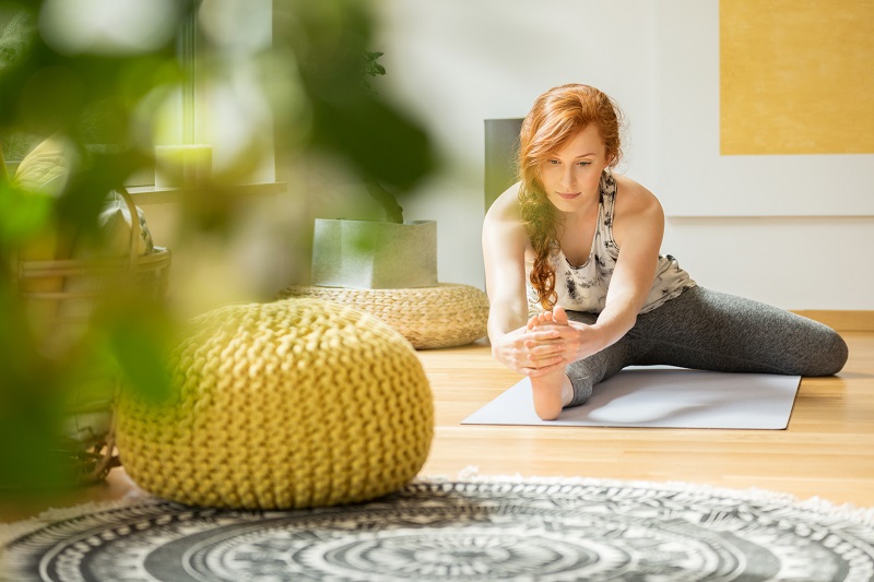 a woman is stretching on a yoga mat 