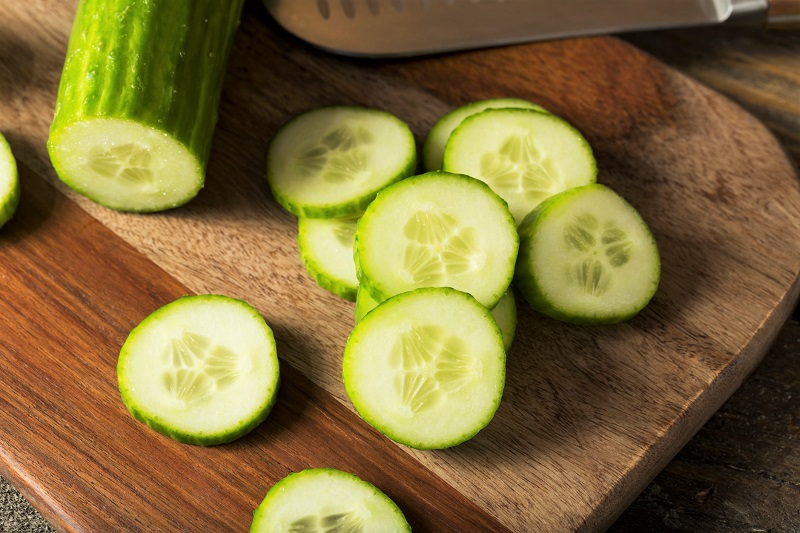 sliced cucumbers on a cutting board
