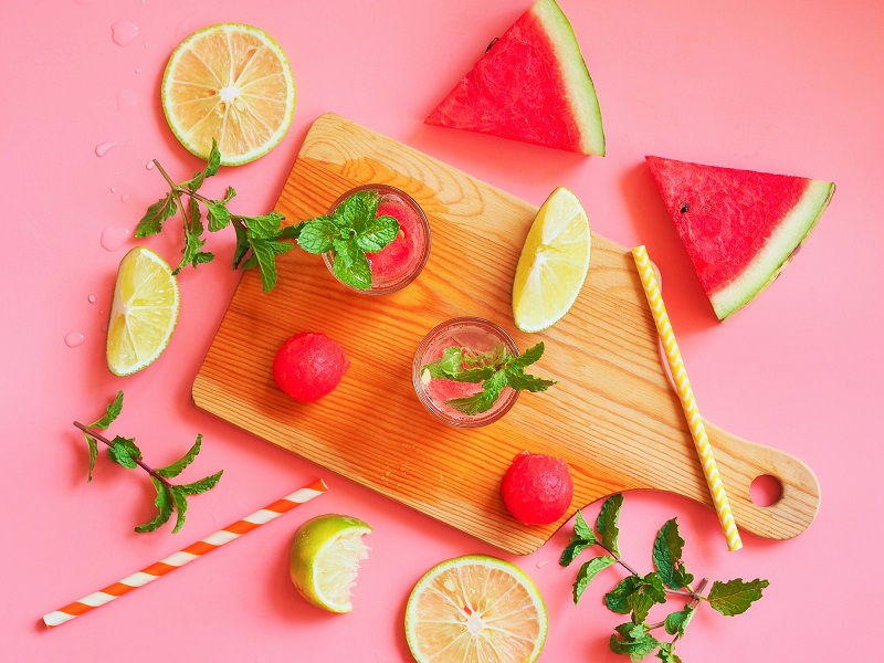 Cutting board with watermelon, limes and mint.