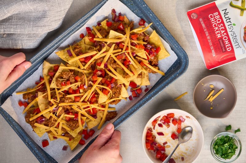Nutrisystem BBQ Seasoned Chicken turned into nachos on a sheet pan